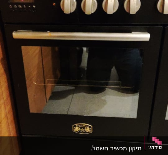 תנור אפייה שחור עם כפתורי שליטה כסופים